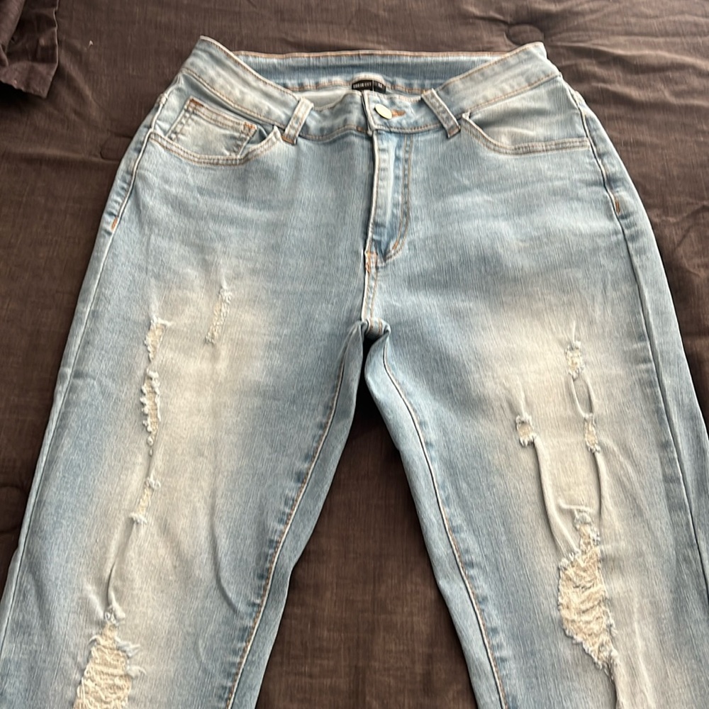 These are light wash ripped jeans from Shein